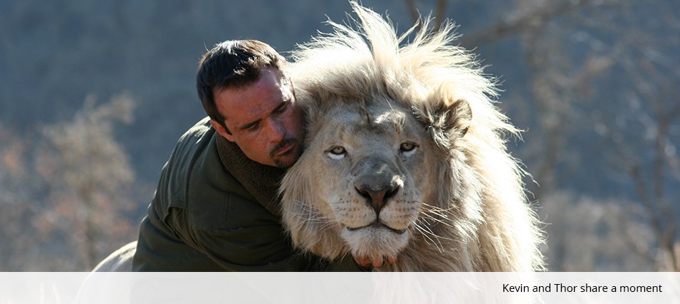 Kevin Richardson playing football with wild lions